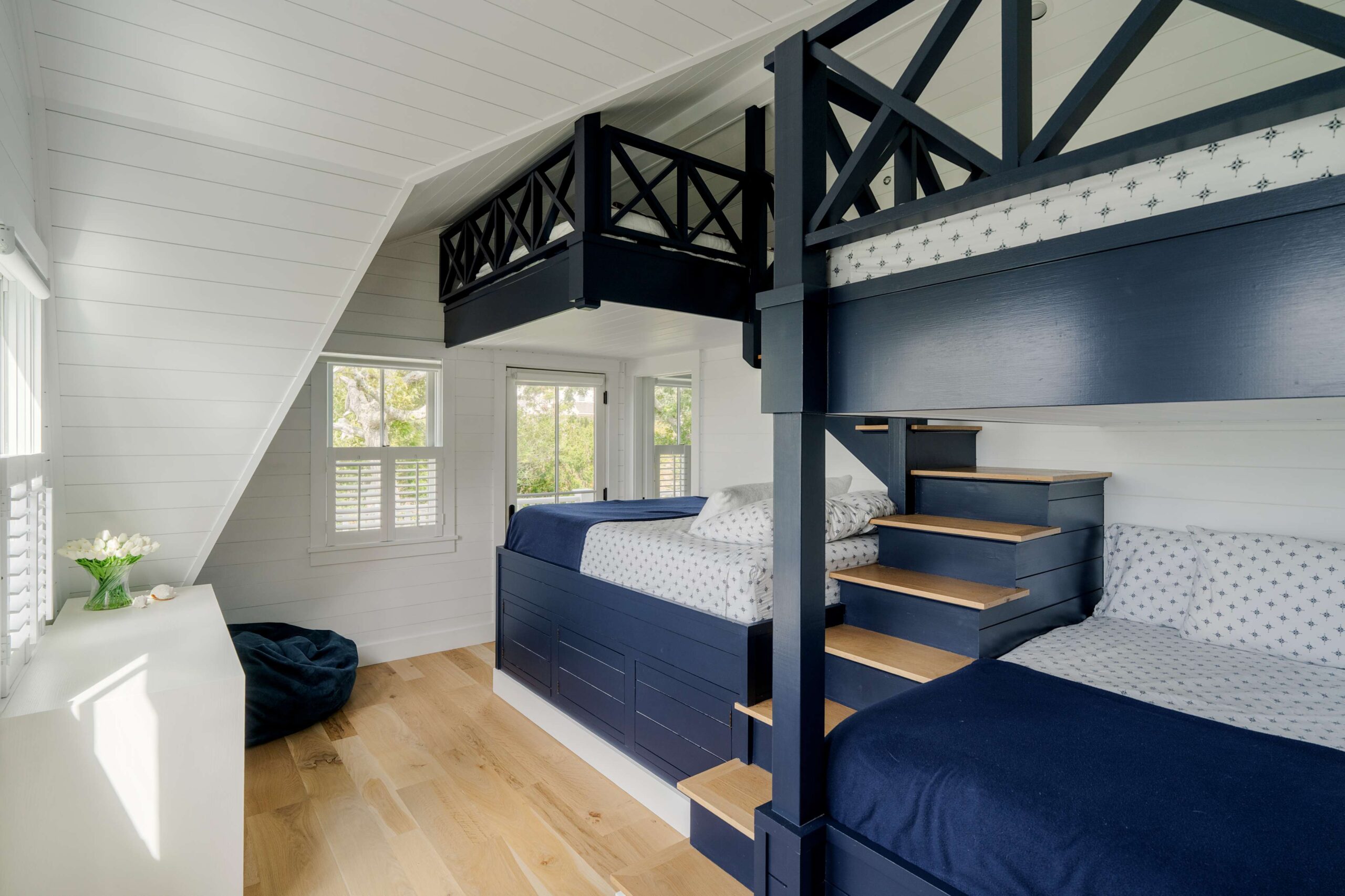 Custom navy blue bunk beds in a the Seaview Avenue, coastal-inspired guest room